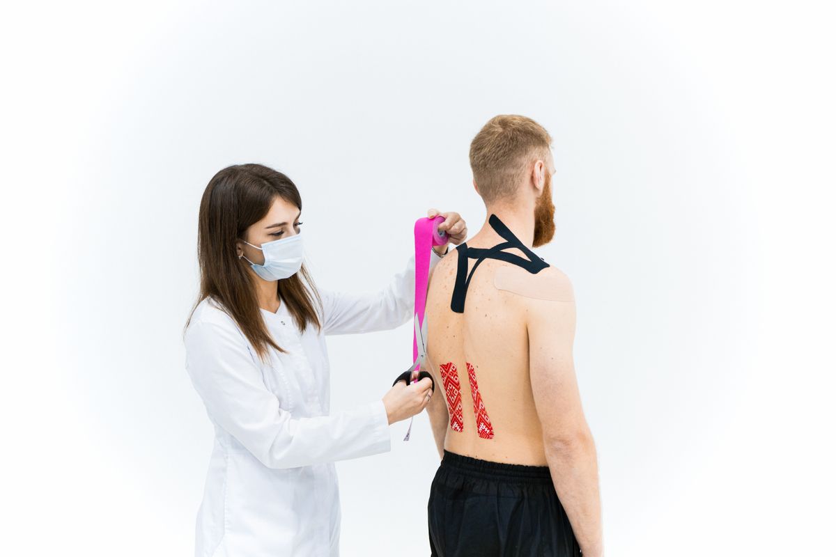 Clinician treating back and shoulder muscle pain in Vancouver